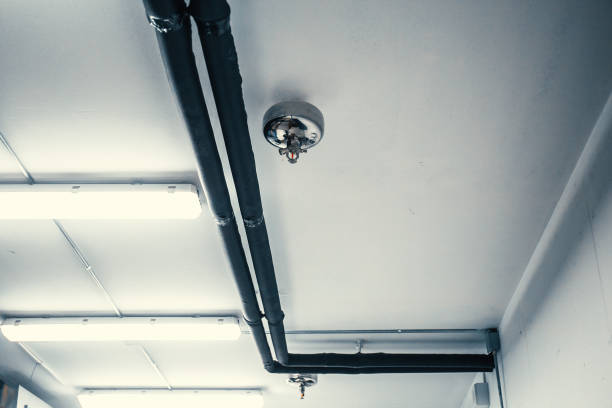 istock Fire sprinkler nozzle and pipes on white celling, automatic fire protection system in buildings 1060864812