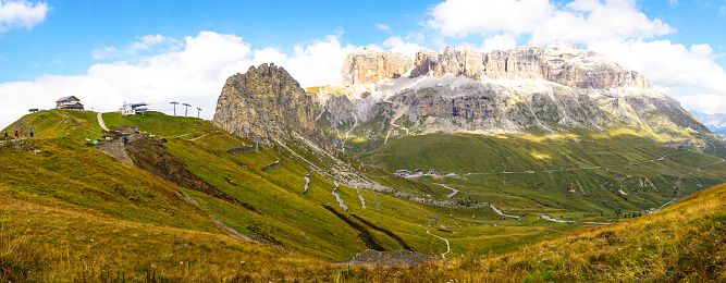 Beautiful view of Sella group, Dolomites and Rifugio Sass Bace from Viel dei Pan hiking path which goes from Fedaia pass to pass Pordoi in Dolomites, Northern Italy, Europe.