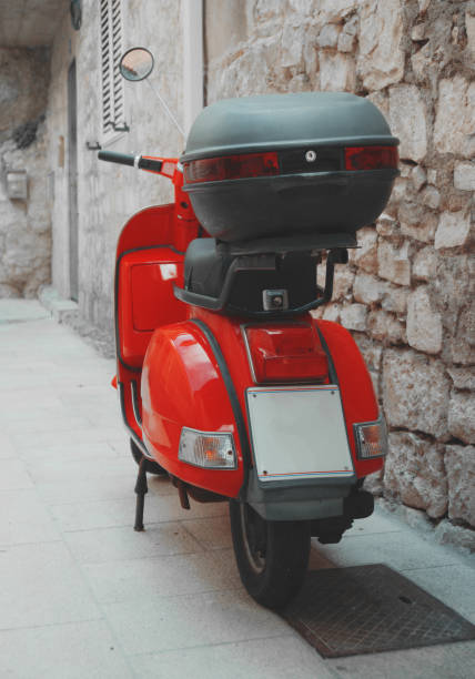 istock Red scooter parked on the empty street. 1060866426