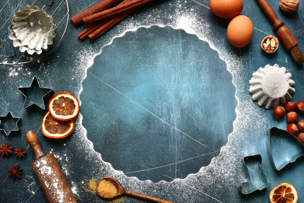Food background with ingredients and props for baking Food background with ingredients and props for baking on a dark blue slate, stone or concrete background.Top view with copy space. walnut cookies stock pictures, royalty-free photos & images