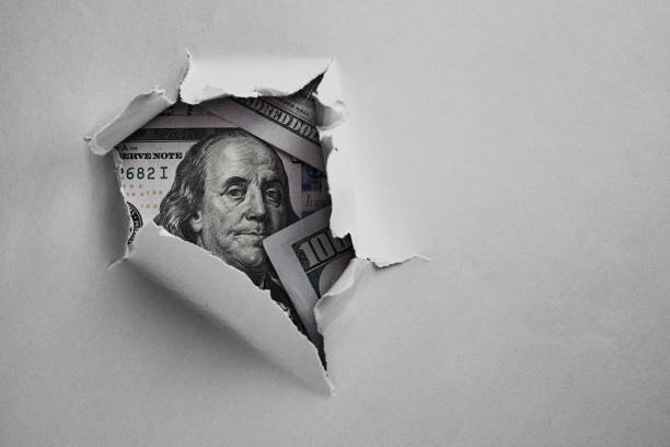 istock Money under holed paper 1060869432