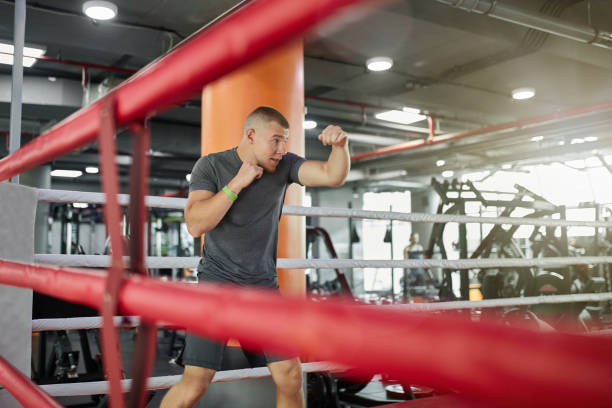 istock Male boxer practicing in boxing ring at gym 1060869798