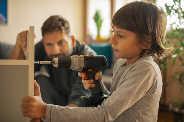 istock Father and son assembling bookshelves at their home 1060869862