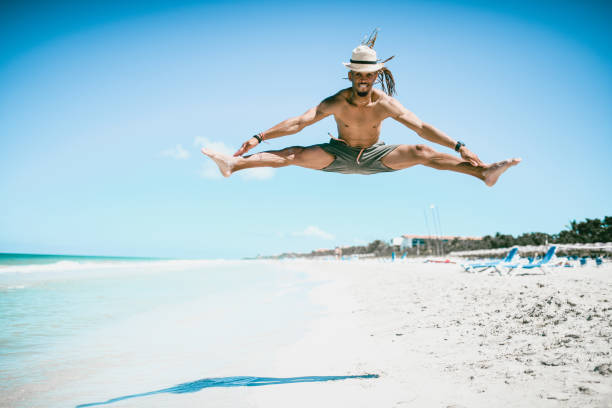 Young Hispanic Male Doing Splits During The Jump On Cuban Beach