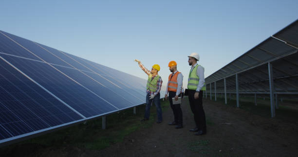 istock Men discussing solar panels on plantation field 1060876740