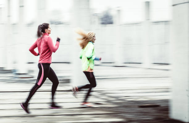 istock Two Female Athletes Running in an Urban Environment, Blurred Motion 1060877090
