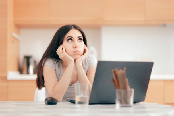 istock Bored Tired Girl Working From Home on Her Laptop 1060877320