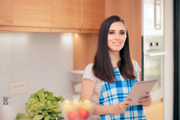 Woman Holding Tablet Pc Looking for Recipes Online