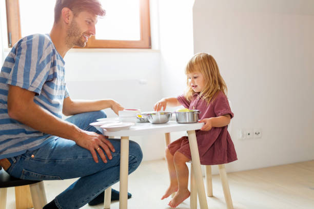 istock Father and daughter having a tea party at home 1060877806