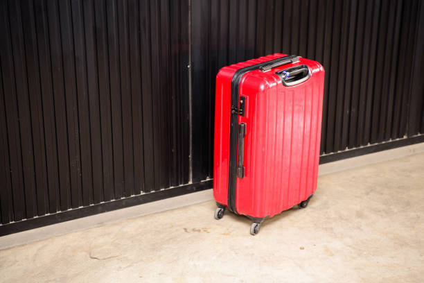 istock Red suitcase Placed in the room coner 1060879572