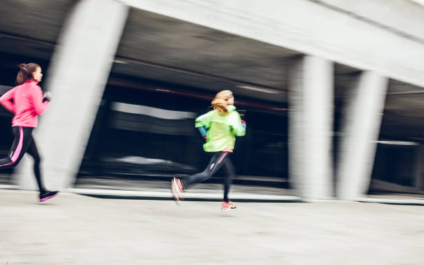 istock Two Female Athletes Running in an Urban Environment 1060879630