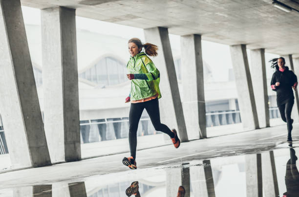 istock Two Female Athletes Running in an Urban Environment 1060882532