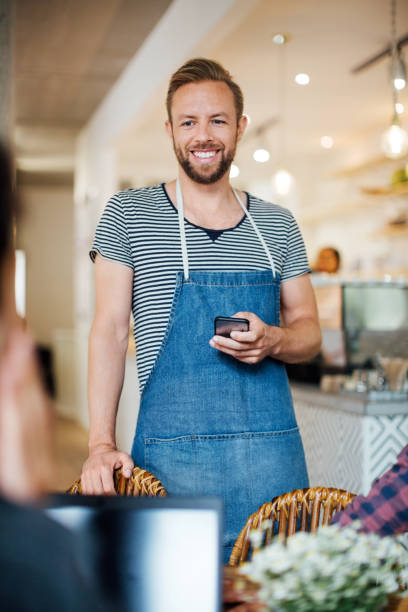 istock Waiter taking order of customers at cafe 1060886276