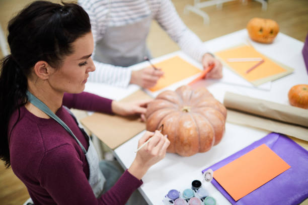 istock Artist painting pumpkin in studio 1060891048