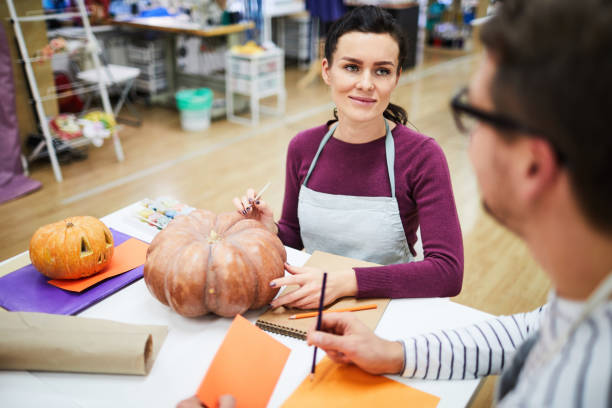 istock Content colleagues working on design of Halloween pumpkins 1060891064