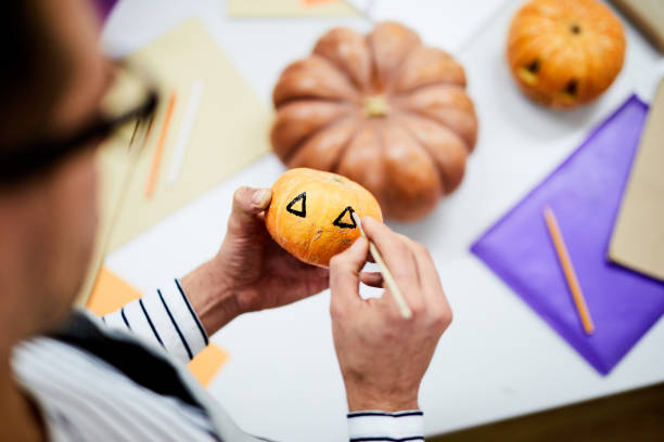 istock Painting eyes on pumpkin 1060891110