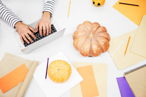 istock Table full of orange papers and pumpkins 1060891118