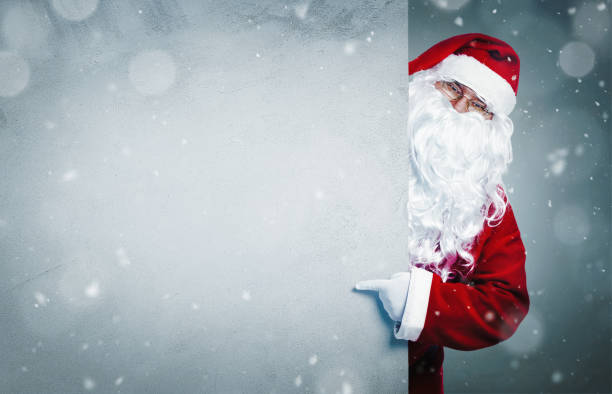 istock Santa Claus pointing on blank banner 1060892692