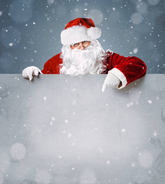 istock Santa Claus pointing on blank banner 1060892976