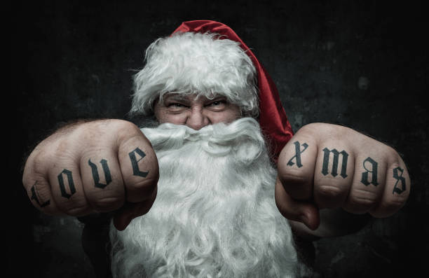 Funny Santa Claus showing fists with love xmas tattoo Funny Santa Claus showing fists with love xmas tattoo on them raised fist photos stock pictures, royalty-free photos & images