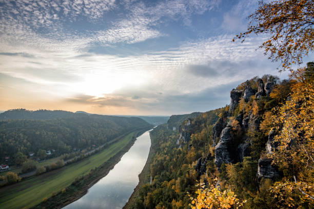 sunset view from the Bastei Rocks on Elbe Valley in Elbsandstein Mountains in the autumn light
