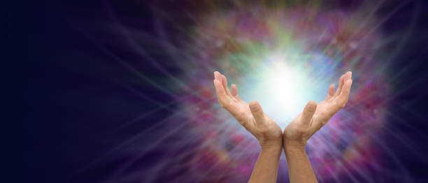 Sending You Gentle Healing Energy female hands facing upwards against a beautiful colourful energy formation with a space for copy on the left side reiki photos stock pictures, royalty-free photos & images