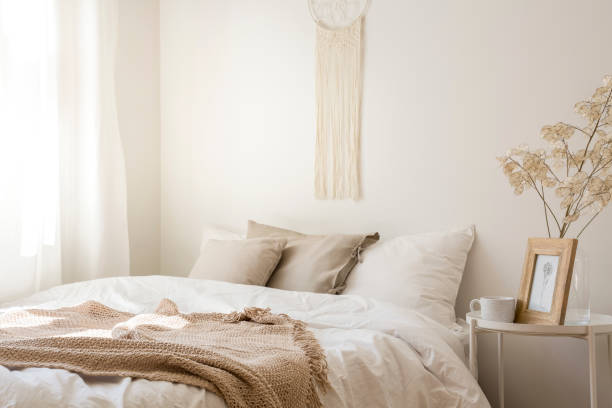 istock Macrame above comfortable king size bed with white bedding, beige pillows and blanket, real photo 1060904736