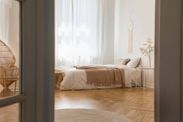 istock White elegant bedroom designed with natural materials, real photo with copy space 1060905808