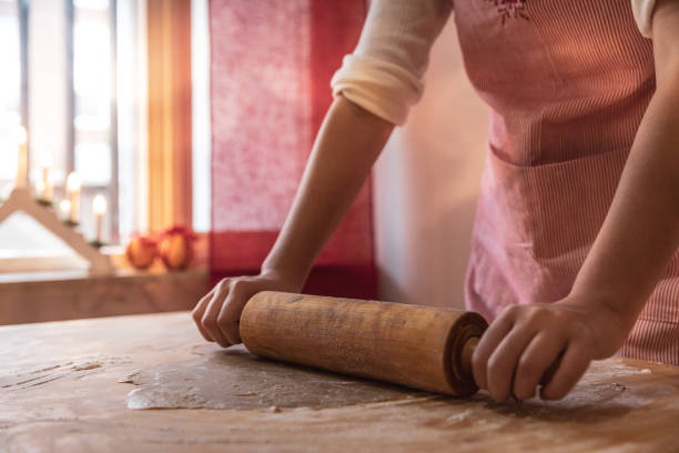 istock Girl making gingerbread cookies 1060907048