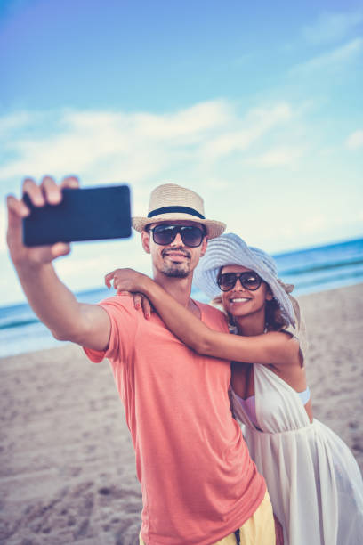 istock Beautiful Couple Is Taking A Selfie On Coastline On A Cuban Beach 1060907390
