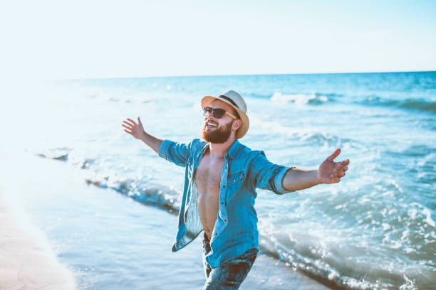 istock Bearded Male With Straw Is Singing On A Coastline 1060907620
