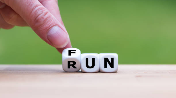 istock Hand is turning dice and changes the word Fun to Run 1060908368