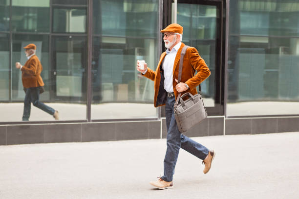 istock Fashionable Senior Man Outdoors Drinking Coffee and walking 1060910260