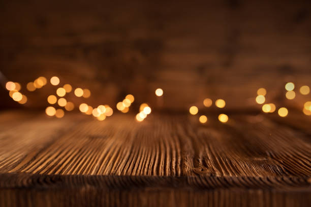 istock Golden christmas lights on wooden table 1060912168