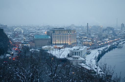 Winter landscape in the town Kiev. Snow covered city at dusk