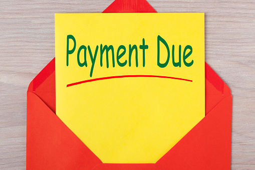 Payment Due written on letter in red envelope. Notice letter.