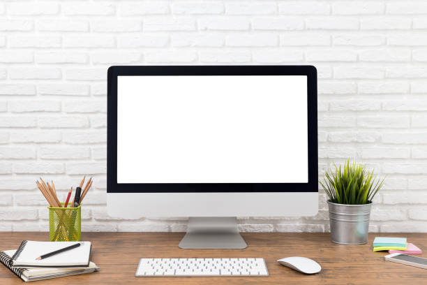 istock workspace with computer with blank white screen, and office supplies on a wooden desk 1060917828