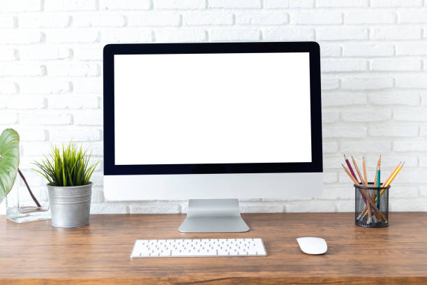 istock workspace with computer with blank white screen, and office supplies on a wooden desk 1060918204