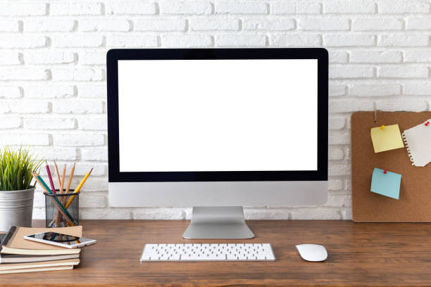 istock workspace with computer with blank white screen, and office supplies on a wooden desk 1060918222