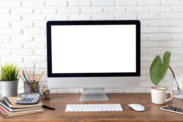 istock workspace with computer with blank white screen, and office supplies on a wooden desk 1060918248