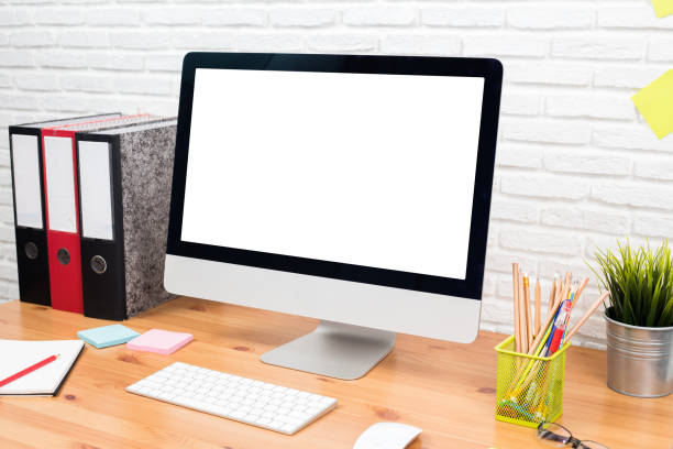 istock workspace with computer with blank white screen, and office supplies on a wooden desk 1060918286