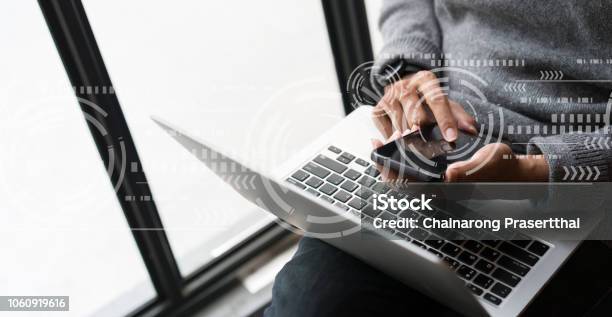 Close Up On Business Man Hand Holding Smartphone For Working Or Using Feature On Application With Virtual Technology Interface Stock Photo - Download Image Now