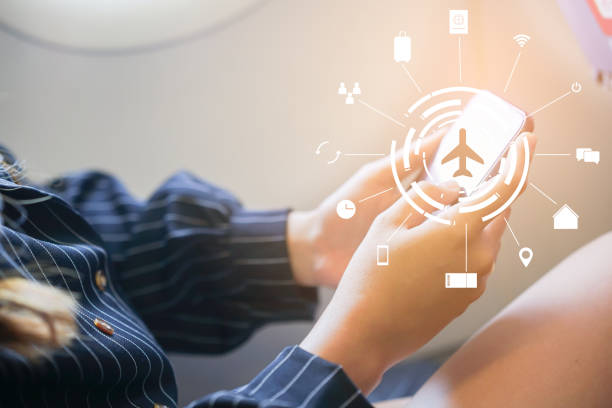 close up businesswoman hand holding smartphone at window seat inside aircraft with virtual interface symbol of travel icon for transportation concept close up businesswoman hand holding smartphone at window seat inside aircraft with virtual interface symbol of travel icon for transportation concept window seat vehicle stock pictures, royalty-free photos & images