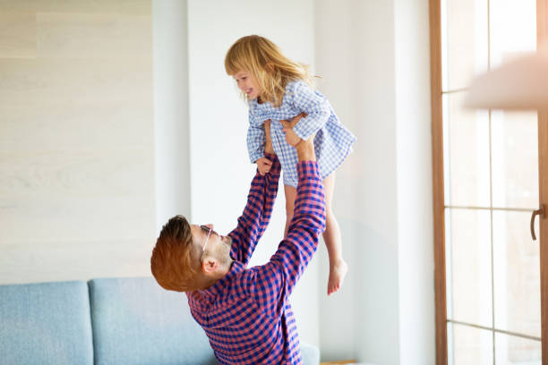 istock Father Playing with Daughter At Home 1060920242