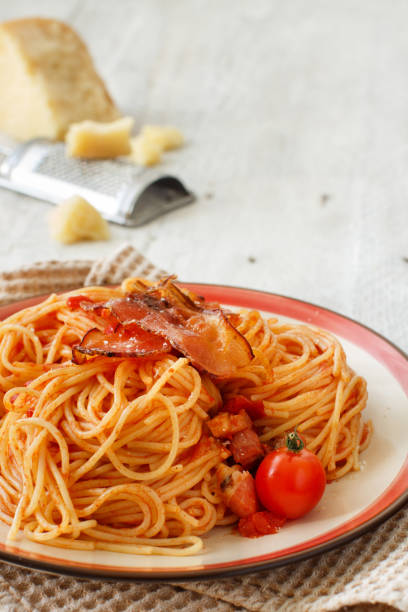 Spaghetti with amatriciana Spaghetti alla amatriciana on a wooden table close up all'amatriciana stock pictures, royalty-free photos & images