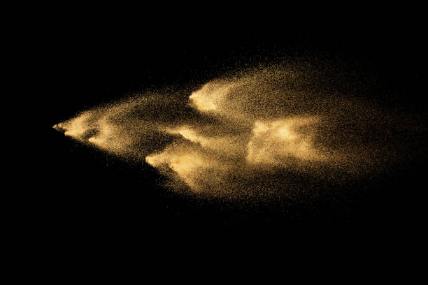istock Golden sand explosion isolated on black background. Abstract sand cloud. 1060927068