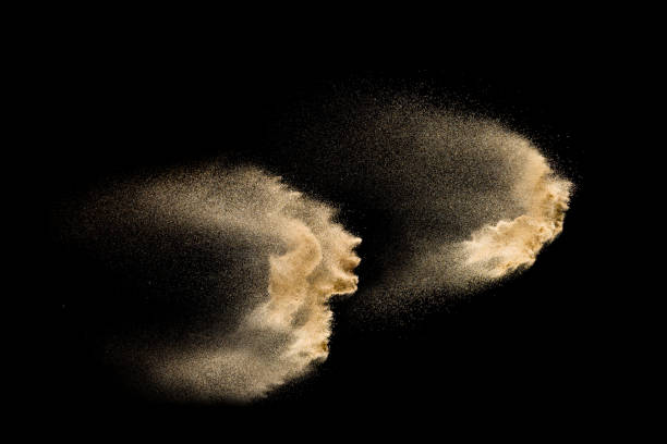 istock Golden sand explosion isolated on black background. Abstract sand cloud. 1060927286