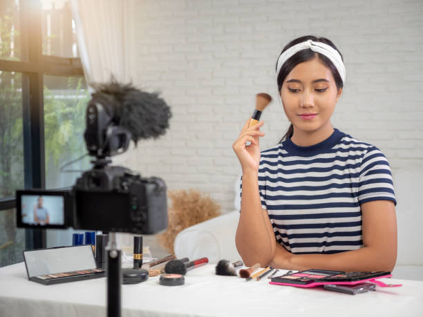 istock Young Asian beauty blogger present cosmetic product and recording her make up tutorial video to social network by internet at home 1060933754