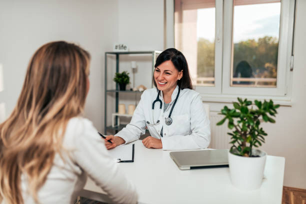 istock Beautiful young female doctor smiling while talking to her patient. 1060937222