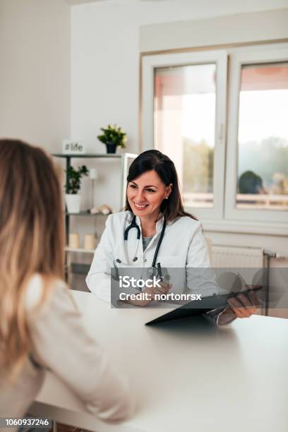 Female Doctor And Female Patient Talking About Test Results Stock Photo - Download Image Now
